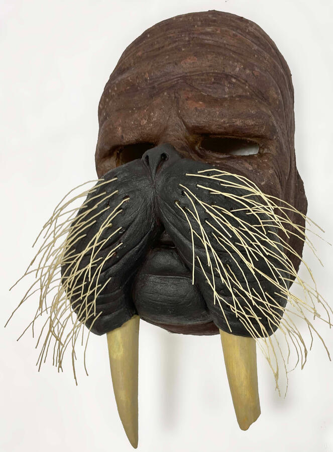 A painted latex mask of a human-animal hybrid character made using a plaster cast of a clay sculpt.