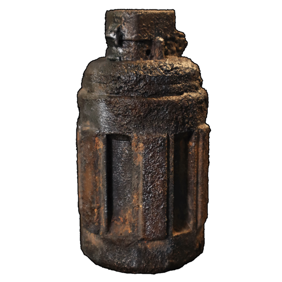 Grenade prop 3D print textured and painted to look as if it has been dug up, with caked dirt and signs of rust.