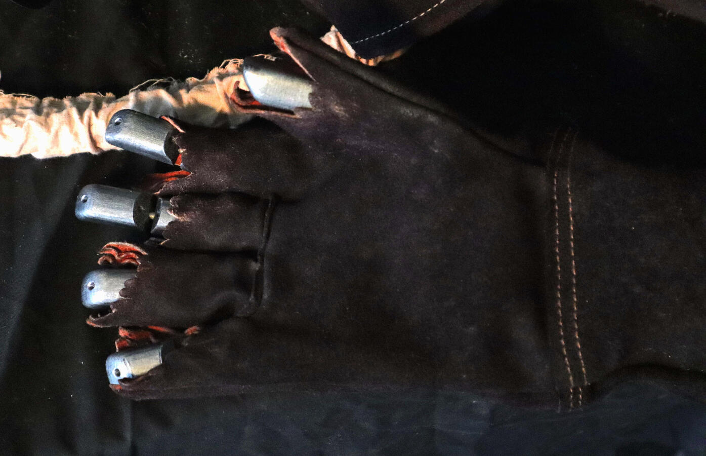 Mechanical hand in torn glove