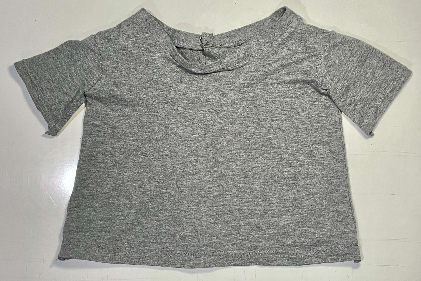 Stitched t-shirt made to fit puppet. Closes with snap buttons on the back