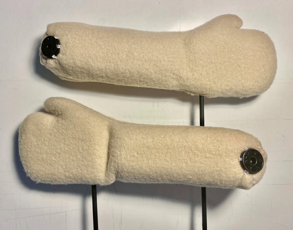 Hands made with foam core, wooden arm rods and polar fleece fabric covering. Attaches to arm with snap buttons at shoulder joint